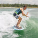 Rider cruising effortlessly in the sweet spot of the wake on the stable Ronix Aloha Longboard.