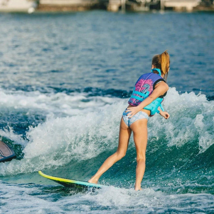 Youth rider performing a precise bottom turn and cutting back into the wake on an Alpha Squad surfer.