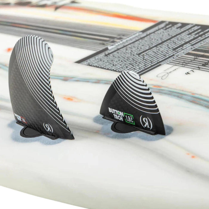 Close-up of the Ronix tool-less button fin box and carbon-fiber quad fin setup on the Atlantik board.
