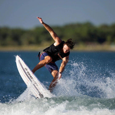 Wakesurfer performing an air 360 rotation on the 2026 Ronix Atlantik Flyweight Pro.
