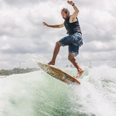 Pro rider Erik Ruck performing a 360 shuv-it on the stable 2026 Ronix Blunt Nose Skimmer.