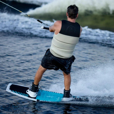 Wakeboarder carving across the wake using the complete 2027 Ronix District board and boot setup.