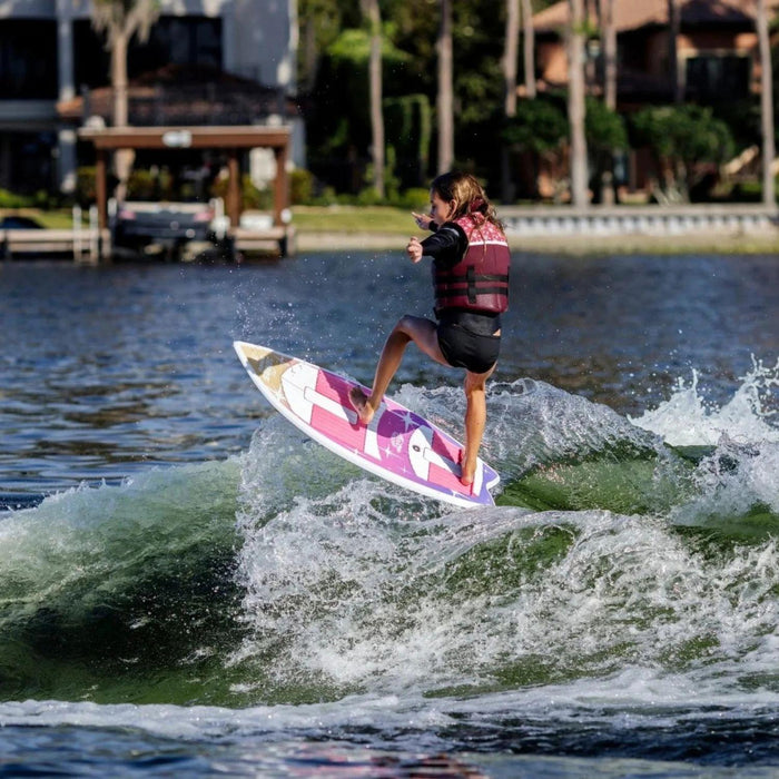 Young girl catching air and performing an ollie on the 2026 Ronix Girl's Fish Sonic.