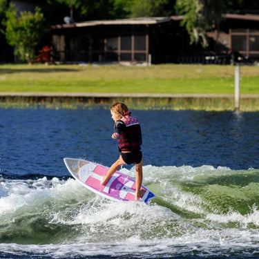 Young girl comfortably surfing the wake on the stable 2026 Ronix Girl's Fish Sonic.