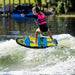 Young girl riding the top of the wave on the Ronix Kid's Powertail Sonic.