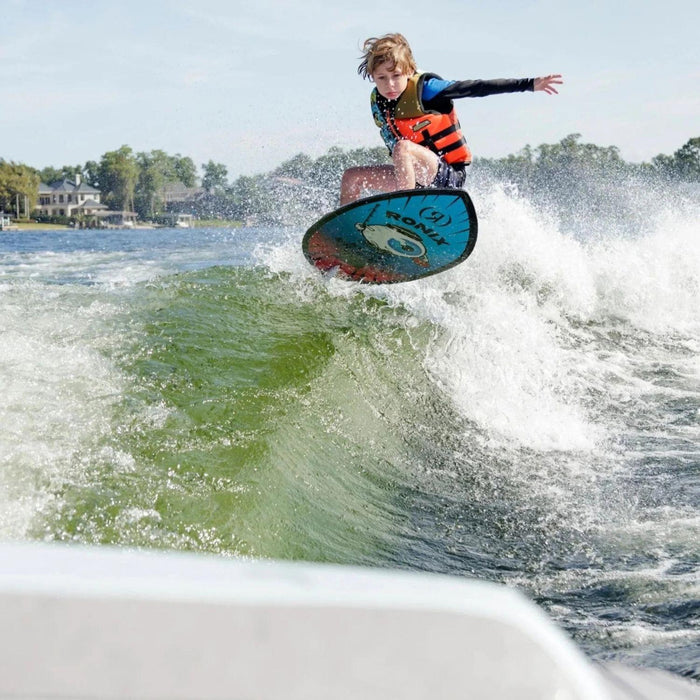 Young boy catching air and performing an ollie on the lightweight Kid's Sonic Skimmer.