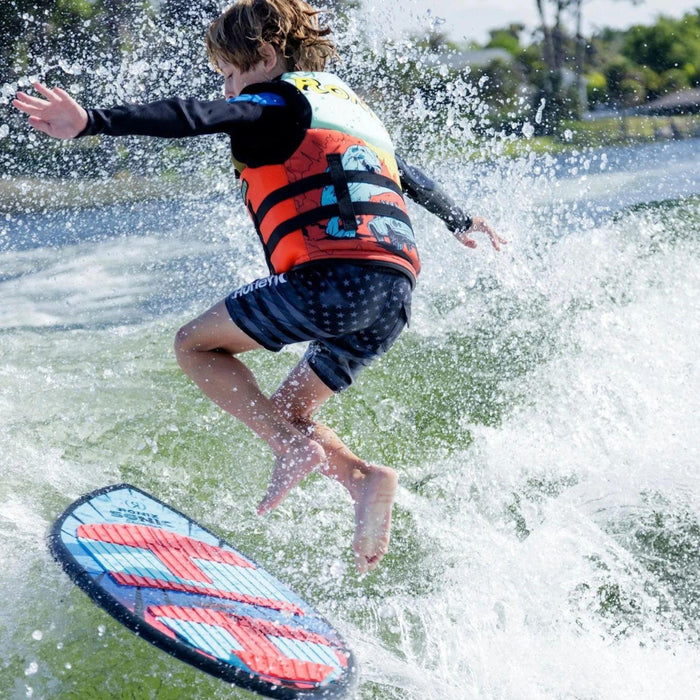 Young rider performing a technical shuv-it on the 2026 Ronix Kid's Sonic Skimmer.
