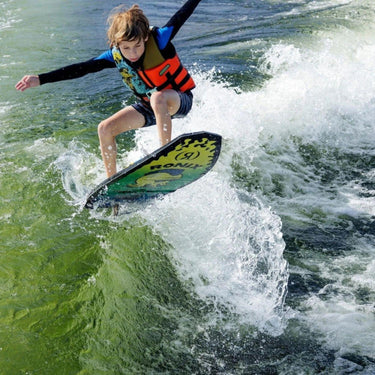Young boy performing an ollie on the 2026 Ronix Powertail Sonic wakesurf board.