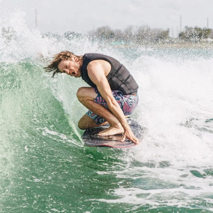 Massi Piffaretti riding on one knee in the pocket of the wake on the 2026 Ronix M50.