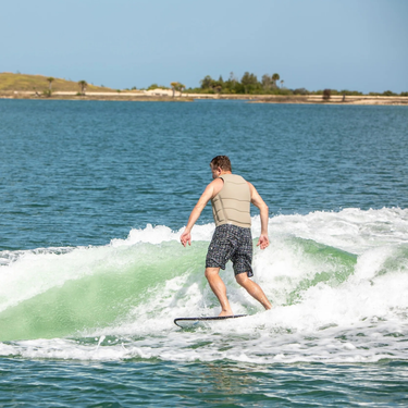 Wakesurfer cruising in the sweet spot of the wake on the versatile Ronix North Shore wakesurf board.