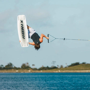 Pro rider Tyler Higham performing a massive inverted air with a tweaked-out grab on the 2026 Ronix One Legacy.