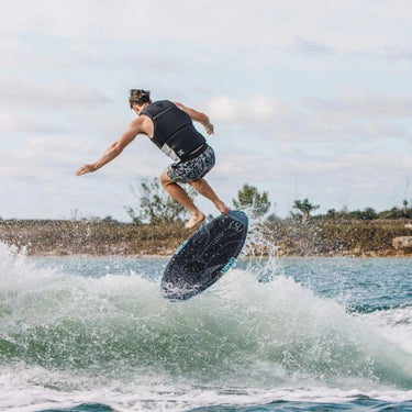 Pro rider Dylan Matthews catching air and performing a shuv-it on his signature Ronix OSMO Skimmer.