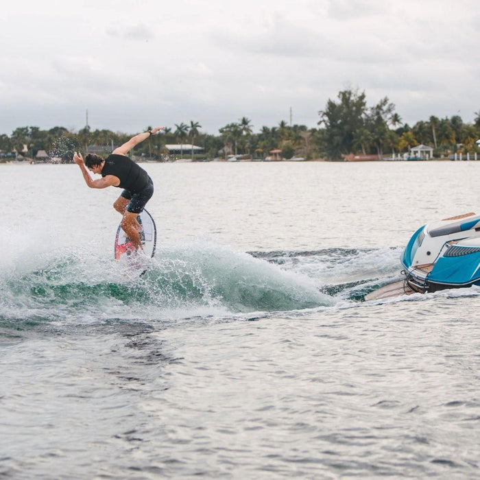Wakesurfer in motion doing a surface 360 on the 2026 Standard Core Skimmer. 