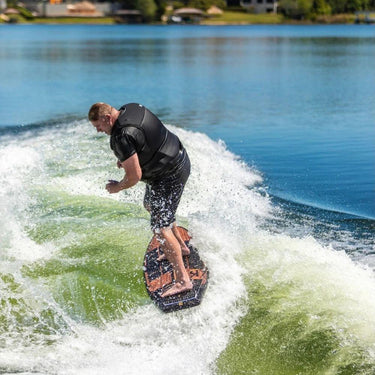 Larger rider demonstrating the loose skim feel of the Ronix Wave King XL Skimmer by performing a surface 360 on the wake. 