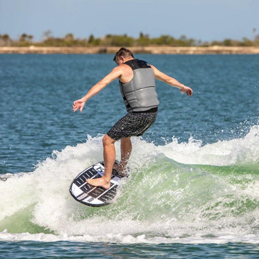 Larger rider executing a smooth slash on top of wake on the 2027 Ronix Wave King XL surfer behind a boat.