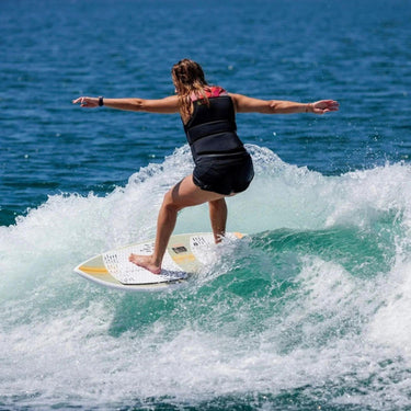 Female rider cruising effortlessly on the beginner-friendly 2026 Ronix Women's Fish wakesurf board.