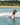 Pro rider Jamie Lopina giving a shaka while cruising on the 2026 Ronix Women's Krush wakeboard.