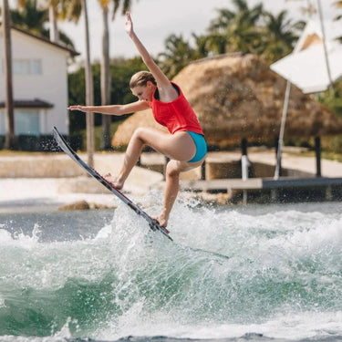 Female rider catching air on the performance-oriented Ronix Women's Sea Captain Tuff Tech.